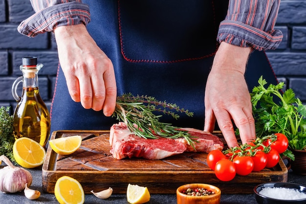 Man cooking beefsteak on a kitchen closeup