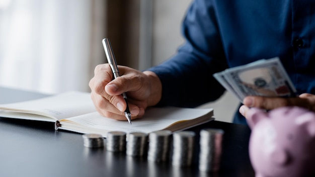 A man counting her salary to separate expenses he keeps a monthly account for savings and investment plans savings and investment ideas to make money grow for wealth