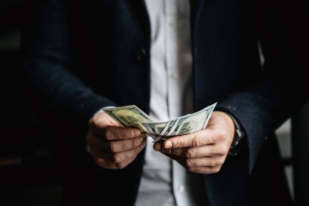  Man counting money,man in business clothes with dollars.