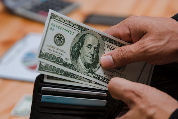 man counting money at the table