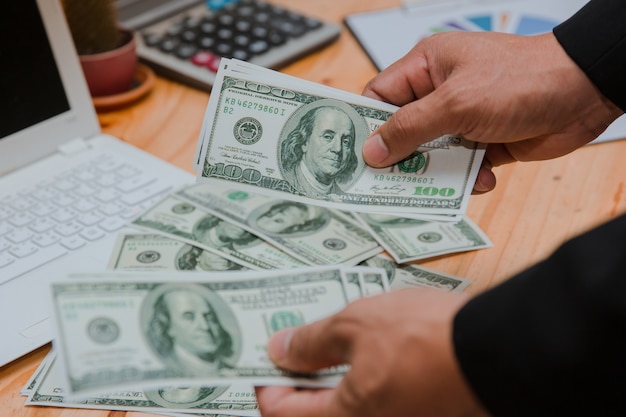 man counting money at the table