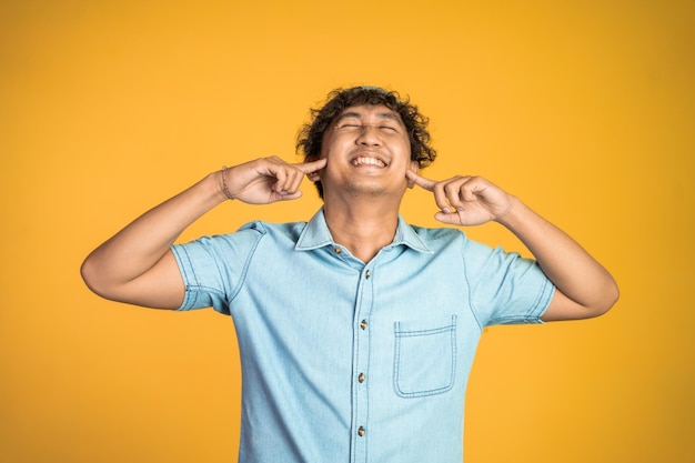 Photo man cover his ear does not want to hear anything