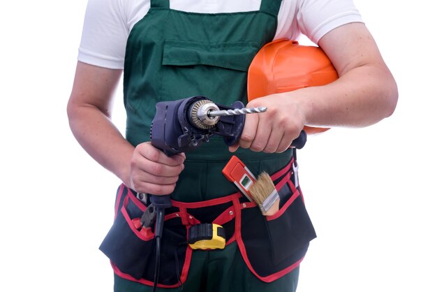 Man in coverall holding drill machine isolated on white