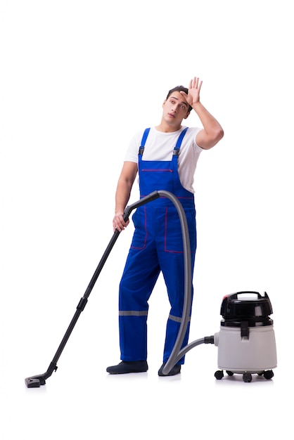 Man in coveralls doing vacuum cleaning on white