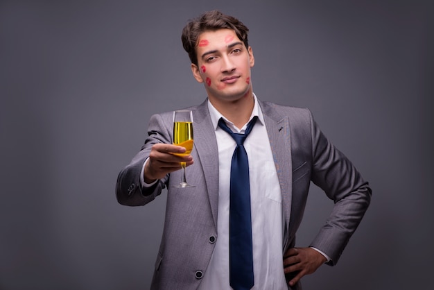 Man covered by kisses with champagne glass