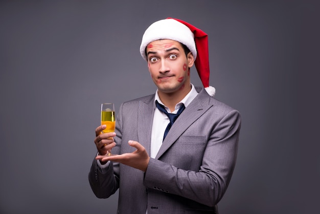 Man covered by kisses with Santa's hat