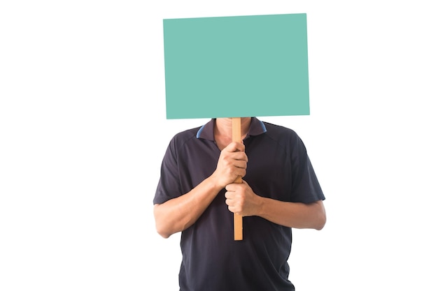 Man covering face with placard against white background