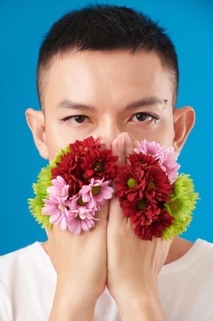 Man Covering Mouth With Flowers