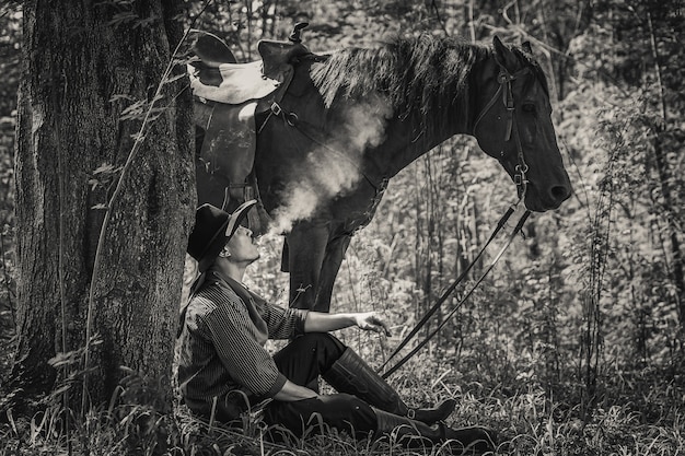 Photo a man in a cowboy outfit with his horse