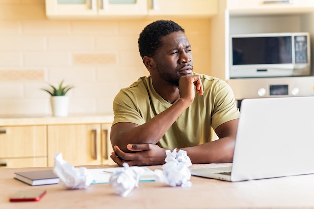 Man crushed paper while working and have no idea remote work in kitchen