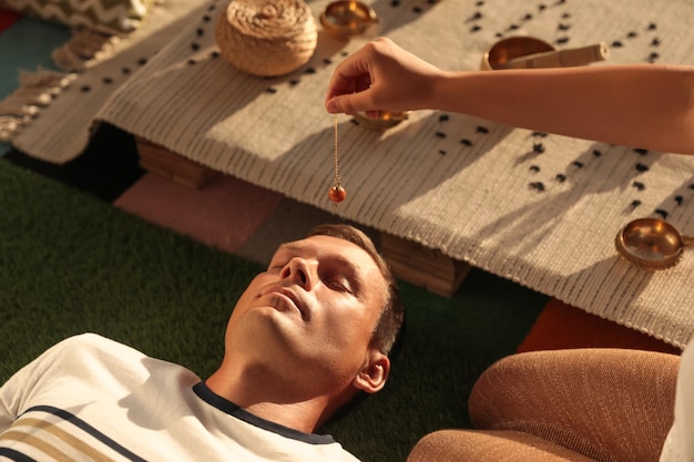 Man at crystal healing session indoors closeup