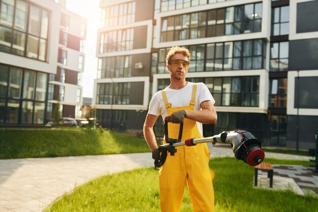 Man cut the grass with lawn mover outdoors in the yard