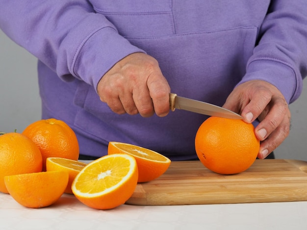 A man cuts oranges