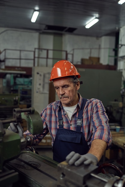 Man cutting metal at lathe