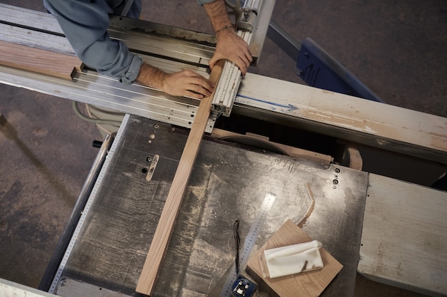 Man cutting the plank