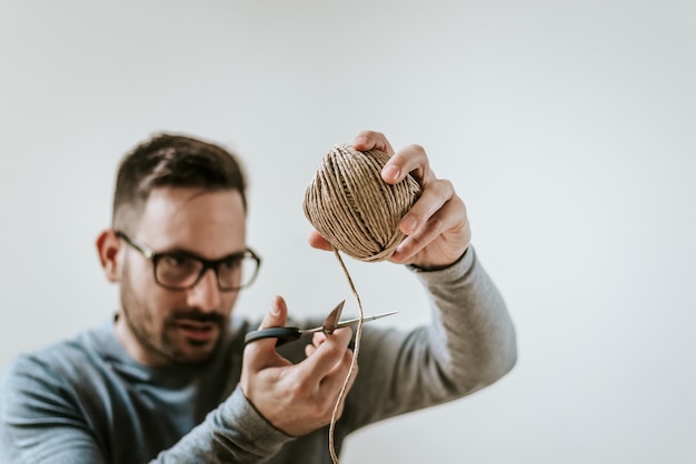 Man cutting twine.