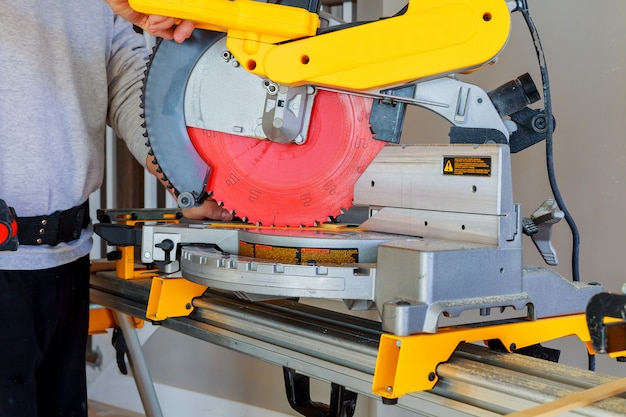 Man cutting wood on electric saw