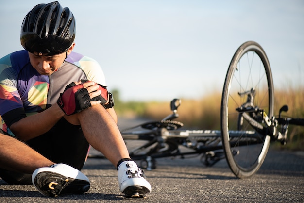 Man cyclist fell off road bike while cycling.