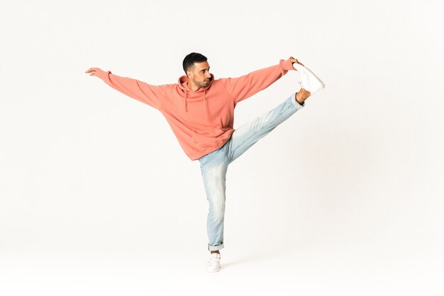 Man dancing street dance style over isolated white wall