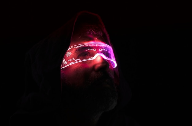 Man in the dark with luminous glasses