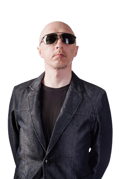 A man in a denim jacket with dark glasses