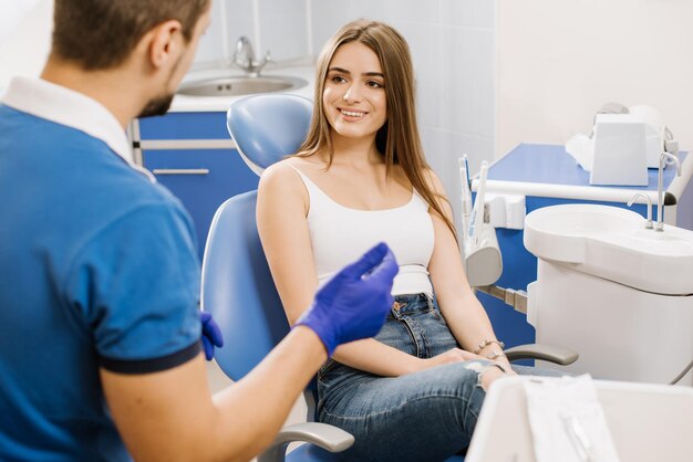 Man dentist having discussion with woman patient