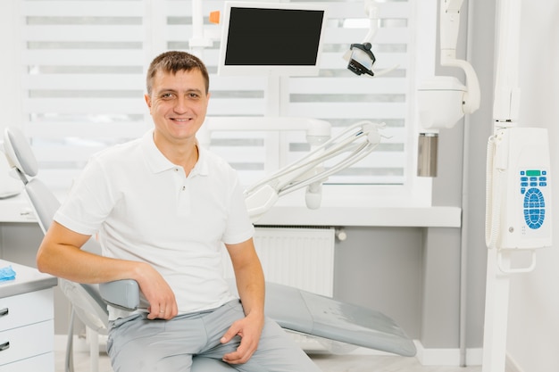 Man dentist at his working place