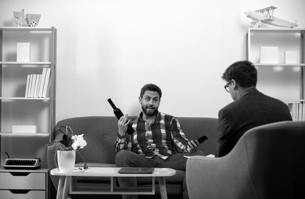 man depressed with wine bottle on psychotherapy session social service psychology patient people abuse and alcoholism problems psychology mental therapy concept