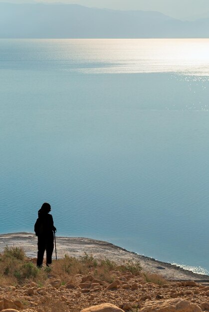 Man in the desert looking at the dead sea israel