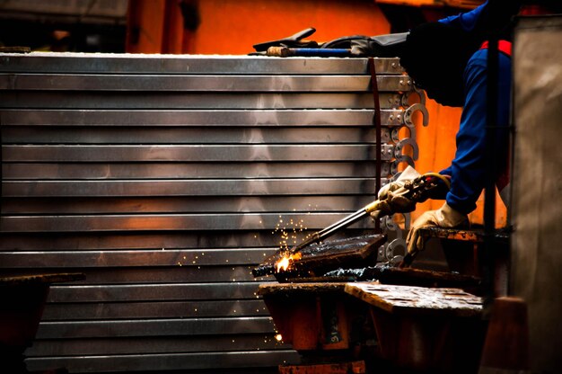 Foto man die aan een metalen constructie werkt