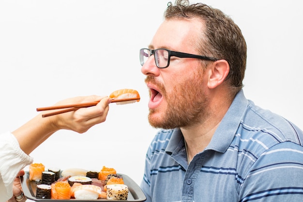 Man die nagiri-zalm eet met stokjes