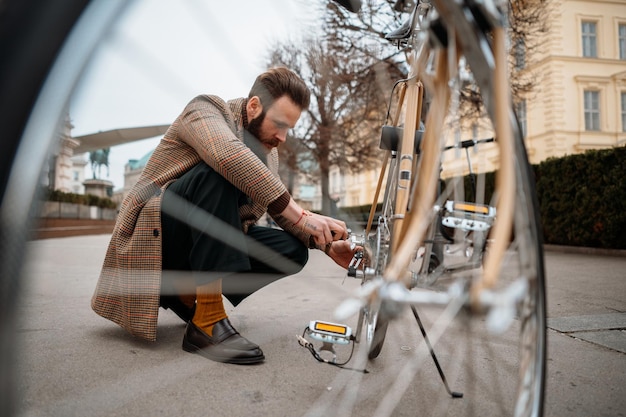 Man die wielen op de fiets controleert Fiets repareren op straat