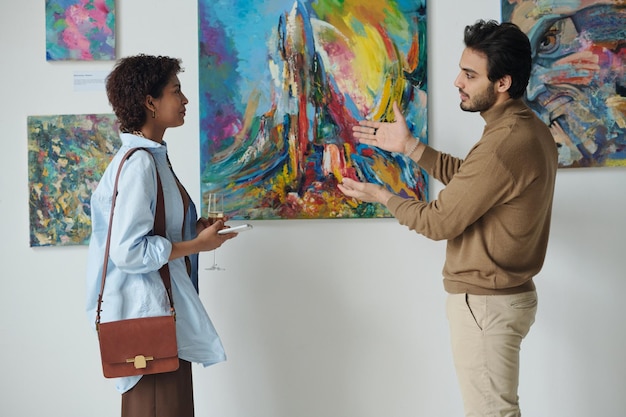 Man discussing art with woman