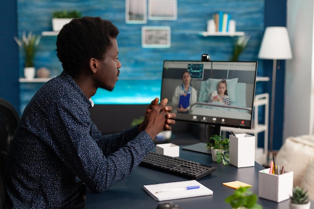 Man discussing with remote therapist about daughter sickness symptoms during videocall telemedicine meeting conference.. Doctor explaining healthcare treatment. Online telework consultation