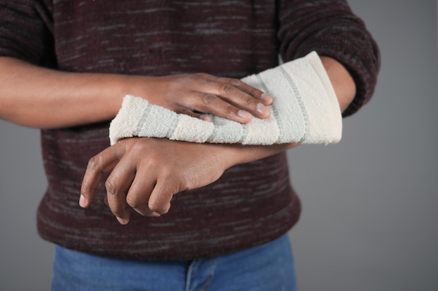 man disinfecting his hands with a wet wipe