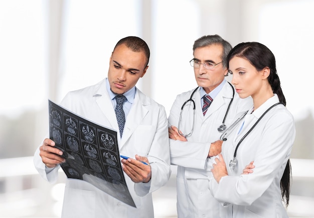 Man doctor holding x-ray  and discussing with Colleagues