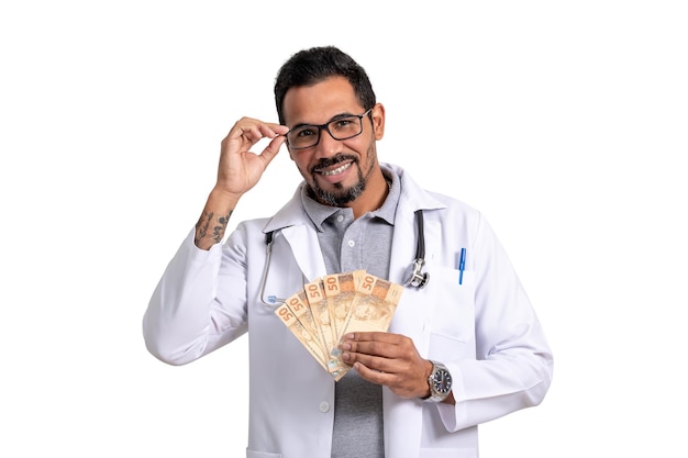 man doctor holds brazilian money, deceased looks at camera, isolated on white background