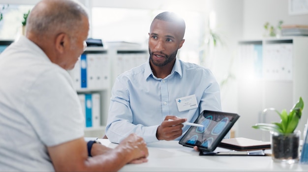 Man doctor and tablet with patient brain scan or consultation for examination results at hospital Male person medical employee or nurse pointing to technology for MRI or x ray at neurology clinic