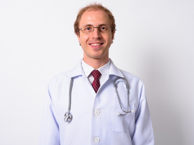  man doctor with blond hair wearing eyeglasses against white wall