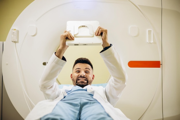 Man doctor with medical report by the MRI scanner