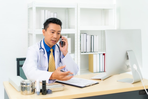 man doctor writing document white talking to consulting patient