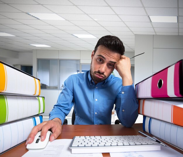 Man doet een saaie baan op zijn computer