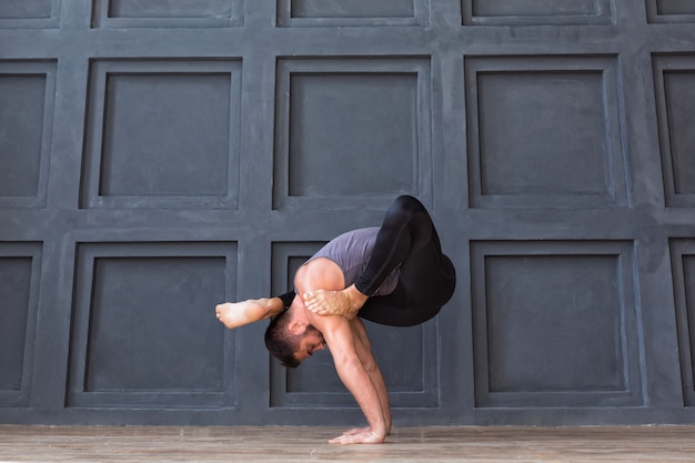 Man doet yoga oefeningen en handstand oefenen