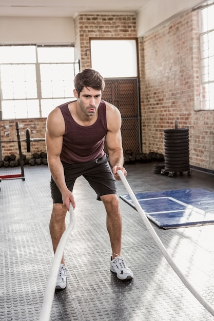 Man doing battling rope exercise