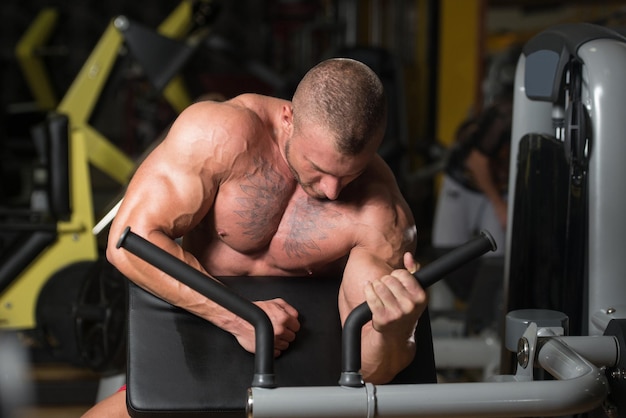 Man Doing Exercise For Biceps On Cable Machine