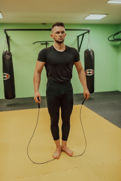 A man doing a jump rope in a gym