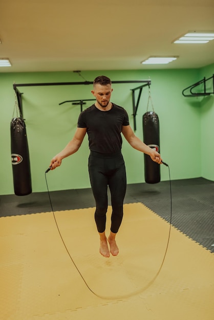 A man doing a jump rope in a gym