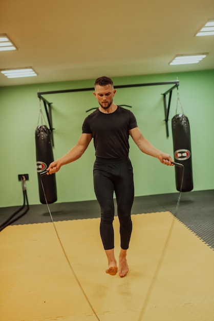 A man doing a jump rope in a gym