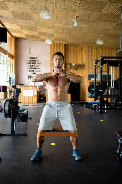 Man doing leg exercises using an elastic band