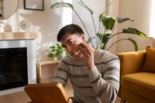 室内で化粧をする男性